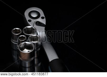 Ratchet Wrench. Set Of Stainless Steel Hex Sockets On Shiny Black Surface. Universal Professional To