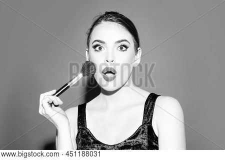 Portrait Of Amazed Woman With Makeup Brush Near Face. Beautiful Woman, Female Skin Care, Close Up Fa