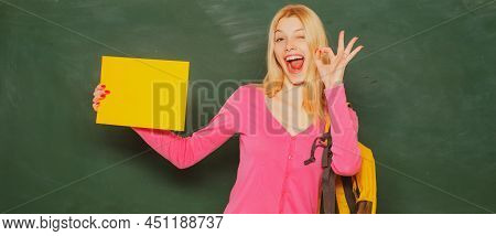 Excited Amazed Teacher. Student Girl Holding Empty Faper For Product. Portrait Of Smiling Female Tea