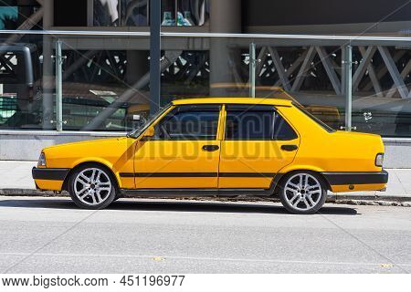 Antalya; Turkey - March 04 2022: Yellow Tofas Dogan Parked On The Street On A Warm Summer Day