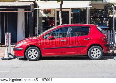 Antalya; Turkey - March 04 2022:    Red Peugeot 307   Is Parked  On The Street On A Warm Summer Day 