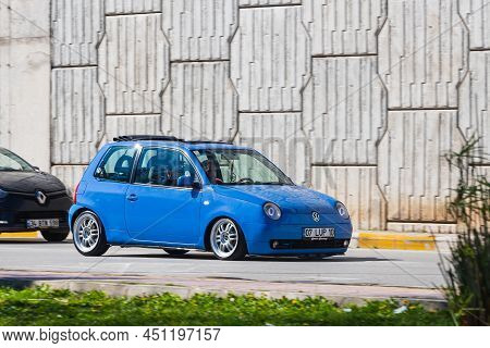 Antalya; Turkey - March 04 2022: Blue Volkswagen Lupo Is Driving Fast On The Street On A Warm Summer
