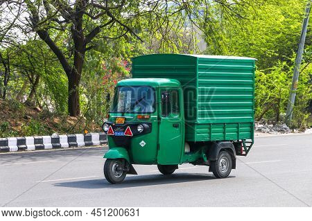 New Delhi, India - February 25, 2022: Green Cargo Three-wheeler Bajaj Maxima In A City Street.