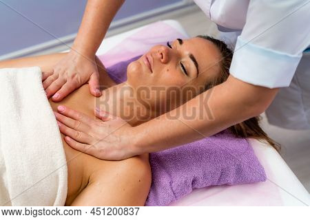 Facial Massage. A Woman Is Given A Massage In A Beauty Salon. Close-up.