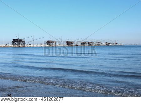 Array Of Many Fishing Sheds On The Sea In Northern Italy Near Sottomarina Town In Venice Province
