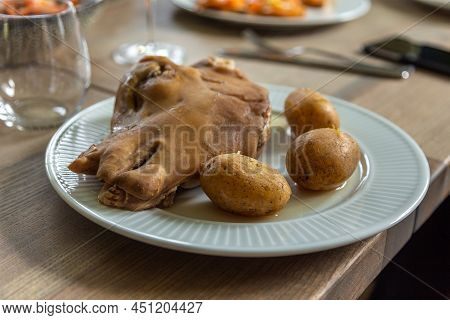 A Sheep Head With Boiled Potatoes, A Traditional Faroese Dish. White Plate On Wooden Table. Soldafjo