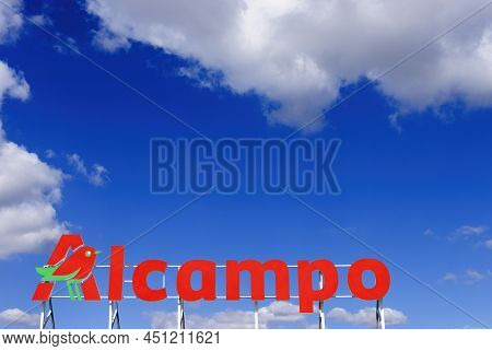 Teruel, Spain, 10-11-2021, Alcampo Supermarket Poster, Hypermarket Signboard Agains Blue Sky With Cl