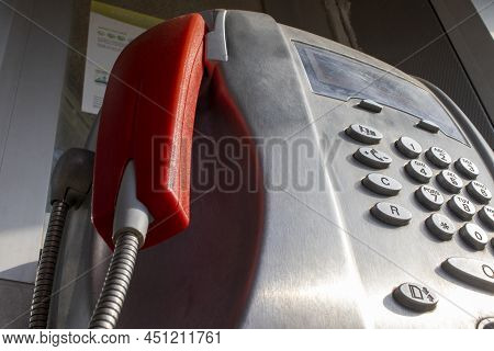 Payphone Close-up. Phone With A Red Tube At A Train Station In Italy. Telecommunication
Concept.