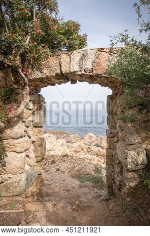 A Stone Doorway With A View Through To The Mediterranean Sea At Davia On The West Coast Of Corsica