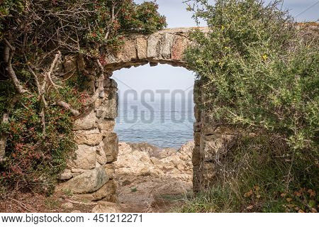A Stone Doorway With A View Through To The Mediterranean Sea At Davia On The West Coast Of Corsica