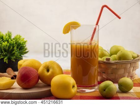 Side View Of Sweet Yellow Peaches On A Wooden Kitchen Board With Pinky-orange Peach With Peach Juice