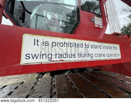Augusta, Ga Usa - 03 19 22: Manitowoc Red Crane Construction Scene Cloudy Rainy Day Prohibited Sign