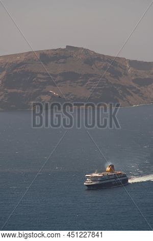 Santorini, Greece - May 10, 2021 - A Ferry Boat Approaching The Port Of Athinios In Santorini And Se