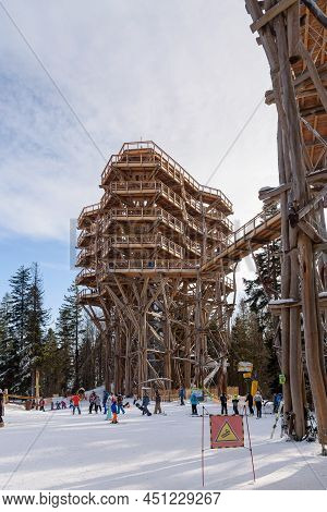 Krynica Zdroj, Poland - January 27, 2020: Skiiers At The Foot Of The Wooden Observation Tower On The
