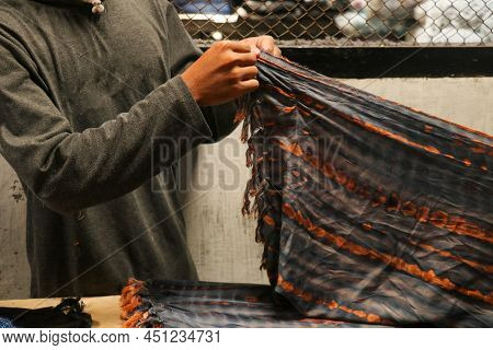Mn Hands Folded The Fabrics In Tailors Workshop. Folded Squared Pattern Sarung, Sarong