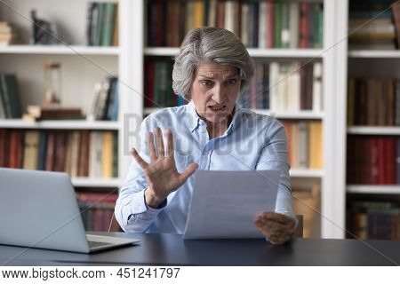Astonished Shocked Older Businesswoman Gawp At Paper Letter