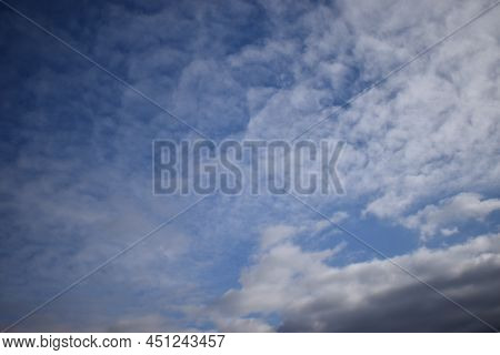 Fleecy Clouds In Blue Sky. Cirrus Clouds Formation With Blue Sky Background. Cirrus Intortus
