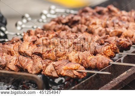 Pork Meat Skewers, Grilled Or Roasted In A Barbecue On An Open Fire And Flames, Shashlik Or Shashlyk