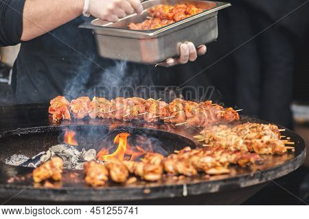 Preparing Chicken Meat Skewers, Grilled Or Roasted In A Barbecue On An Open Fire And Flames, Shashli