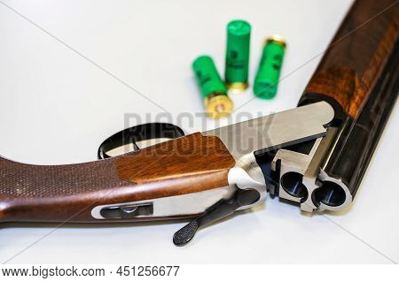 Fragment Of A Double-barreled Shotgun And Cartridges On A White Background. Close-up. Selective Focu