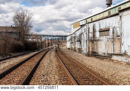 Braddock, Pennsylvania, Usa March 19, 2022 Train Tracks In An Industrial Area With The Rankin Bridge