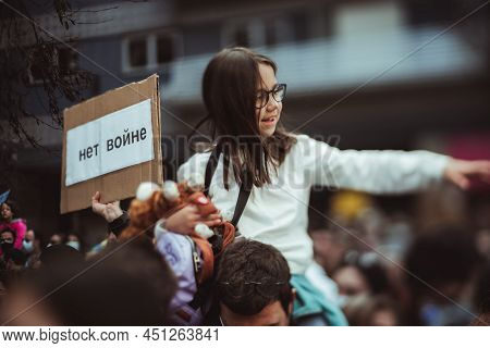 Lisbon, Portugal - February 27, 2022: A True Tilt-shift Shot Of A Smiling Portuguese Girl Sitting On