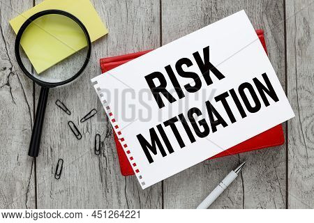 Risk Mitigation Text On White Paper On Red Notepad