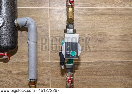 Water Circulation Pump For Underfloor Heating In A Modern Gas Boiler Room Lined With Ceramic Tiles, 