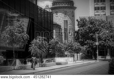 Toronto, Canada - 06 17 2016: A Woman Walking Along The Devonshire Pl In Front Of The Goldring Centr