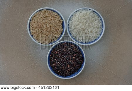 Various Types Of Rice : Brown Rice, Jasmine Rice, Riceberry Ceramic Cup. Organic Raw Rice Collection