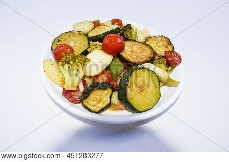 Fresh Homemade Salad Made With Red Cherry Tomato, Broccoli, Peach, Green Zucchini Tasty On White Bac