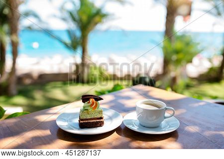 A Cup Of Coffee And A Cheese Cake Against The Mountain And The Lake View At Mount John ,lake Tekapo,