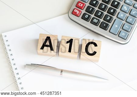 A1c Test Text, Diabetes Diagnosis On Wooden Cubes On The Table Next To The Notebook. Medical Concept