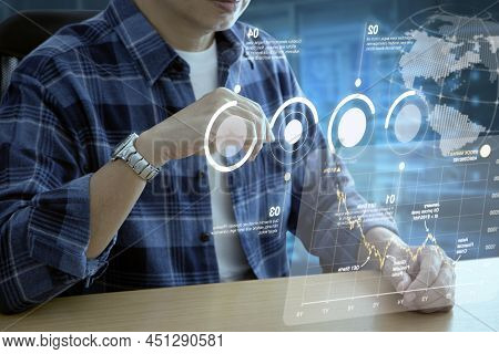 Man In Casual Cloth Interacting With Futuristic Augmented Reality Virtual Screen Of Business Informa