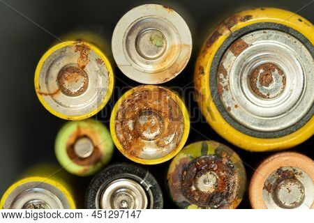 Closeup Of Used Battery With Traces Of Rust And Corrosion, Selective Soft Focus. Macro Shot Of Lot O