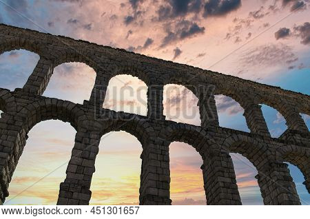 Backlit Contour Of The Millenary Roman Aqueduct Of Segovia, Spain