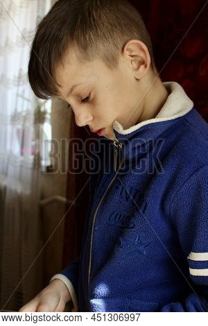 The Beautiful Boy In Blue Sweater Playing Game