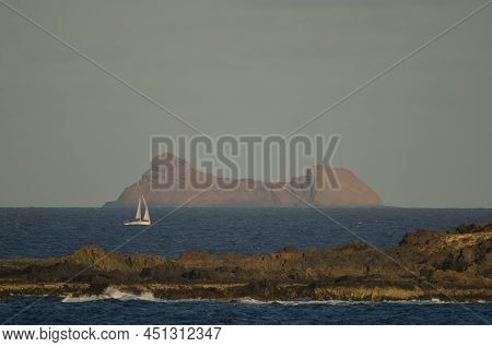 Sailboat Sailing Between La Graciosa And Roque Del Este. Chinijo Archipelago Natural Park. Canary Is