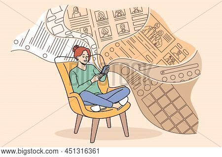 Smiling Millennial Girl Sit Relax In Chair Scroll Social Media Feed On Smartphone. Happy Young Woman