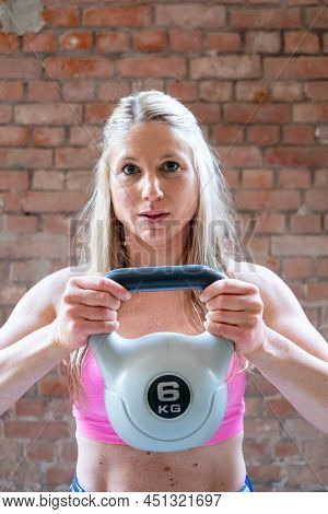 Young Muscular Woman Doing High Pull Exercise With Kettlebells On Hard Training At The Garage Gym. H