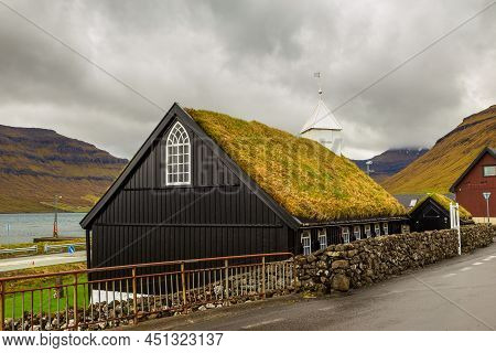 View Of The Kollafjordur Church, Kirkja In Small Village On Streymoy Island. Cloudy Day. Kollafjordu