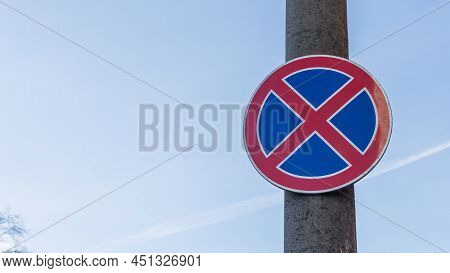 Red And Blue Traffic Sign In Front Of Beautiful Blue Sky Says Absolute No Stopping Here Also On The 