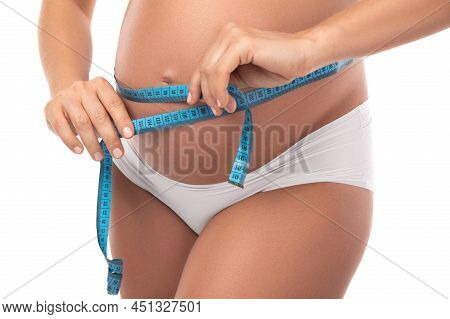 Pregnant Woman With Measuring Tape Is Checking Her Belly Girth