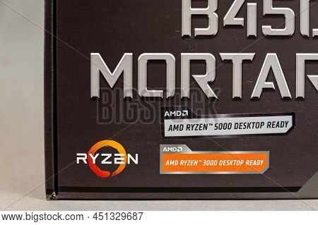 Msi B450 Mortal Max Motherboard Against A Gray Background. Black Box With The New Computer Hardware.