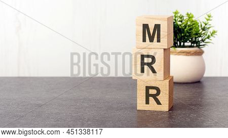 Letters Of The Alphabet Of Mrr On Wooden Cubes, Green Plant, White Background. Mrr - Short For Month
