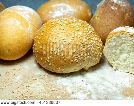 Bakery Products. Table In The Bakery. Buns On A Cutting Board. Rye And Wheat Buns. Products From Pre