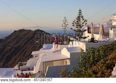 Imerovigli, Santorini, Greece - June 29, 2021: Whitewashed Houses With Terraces And Pools And A Beau