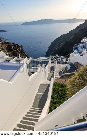 Imerovigli, Santorini, Greece - June 29, 2021: Whitewashed Houses With Terraces And Pools And A Beau