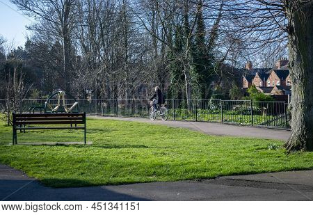 Grantham, England- March 10, 2022. Cyclist In Grantham's Wyndham Park.