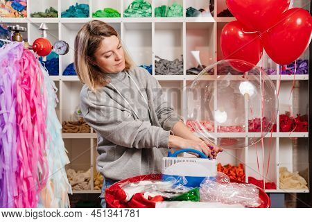 Woman Aerodesigner Stretches Air Clear Balloon Before Inflating It Helium.